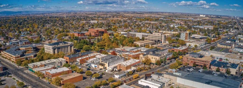 An aerial view of the city of Greeley. Showcasing its unique architecture and colorful atmosphere. Great place for homeowning. Get a quote from Robert Castle Mortgage today.