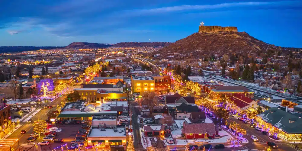 Castle Rock | rcastlemortgage.com An aerial view of castle rock beautifully illuminated by the glow of businesses and street lights. Great place for homeowning. Get a quote from Robert Castle Mortgage today.