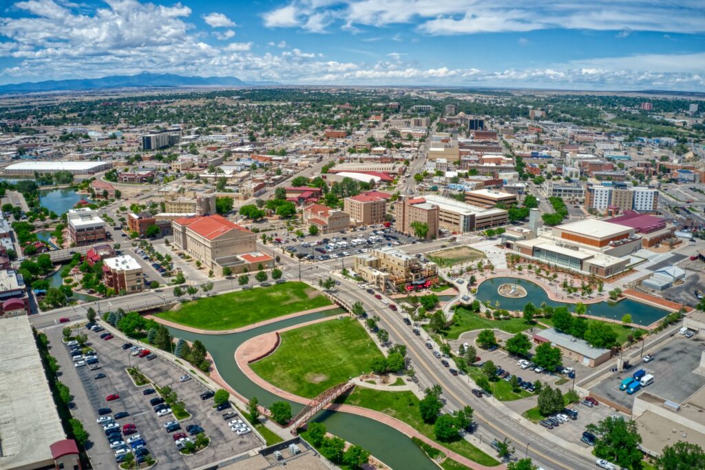 Commerce City | rcastlemortgage.com Aerial view of Commerce City, Colorado, showcasing urban development and surrounding landscapes. Great place for homeowning. Get a quote from Robert Castle Mortgage today.